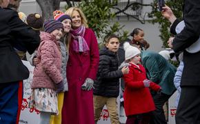 First lady Jill Biden takes a photo with guests during a Toys for Tots event with local Marine Corps and military-connected families on the South Lawn of the White House, Wednesday, Dec. 6, 2023, in Washington.