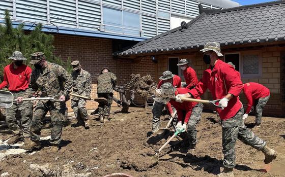U.S. and South Korean troops clean up Ocheon Market in Pohang, South Korea, Wednesday, Sept. 7, 2022, in the wake of Typhoon Hinnamnor. 