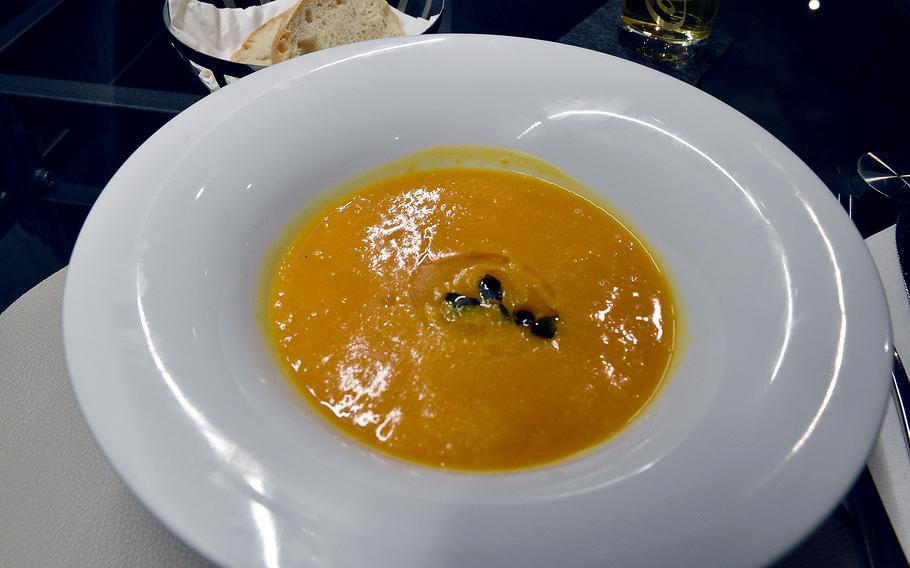 Pumpkin cream soup was a daily special visit at Caruso Ristorante and Vini in Kirchheimbolanden, Germany, on Nov. 2, 2023. The soup came with two slices of bread for dipping.
