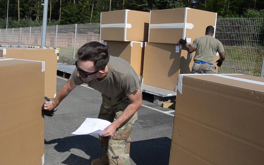 Staff Sgt. Austin Tembrock, captain of Team PDLC, short for Port Dawgs Learning Center, checks a piece of cargo in the pallet building event during the 721st Aerial Port Squadron Multi-Capable Airmen Rodeo. The competition simulates situations airmen might encounter in the real world in order to improve and expand their skillsets.