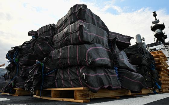 Huge bales of seized drugs on pallets.