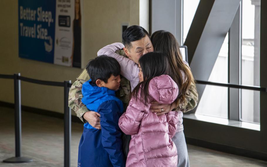 Capt. Marc Ueda embraces his family while being welcomed home Jan. 13, 2024, at Eppley Airfield in Omaha, Neb.