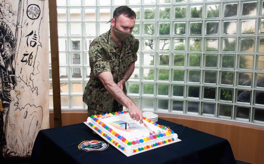 Capt. Rich Jarrett, commander of Fleet Activities Yokosuka, cuts a celebratory cake at a LGBT Pride Month cake-cutting ceremony on June 25, 2020. 