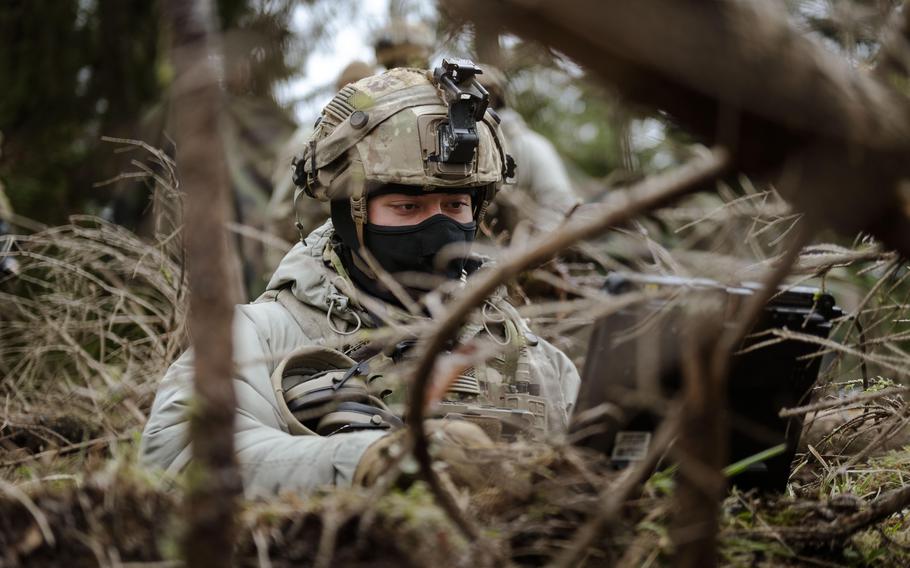 An infantryman nestled in the grass.