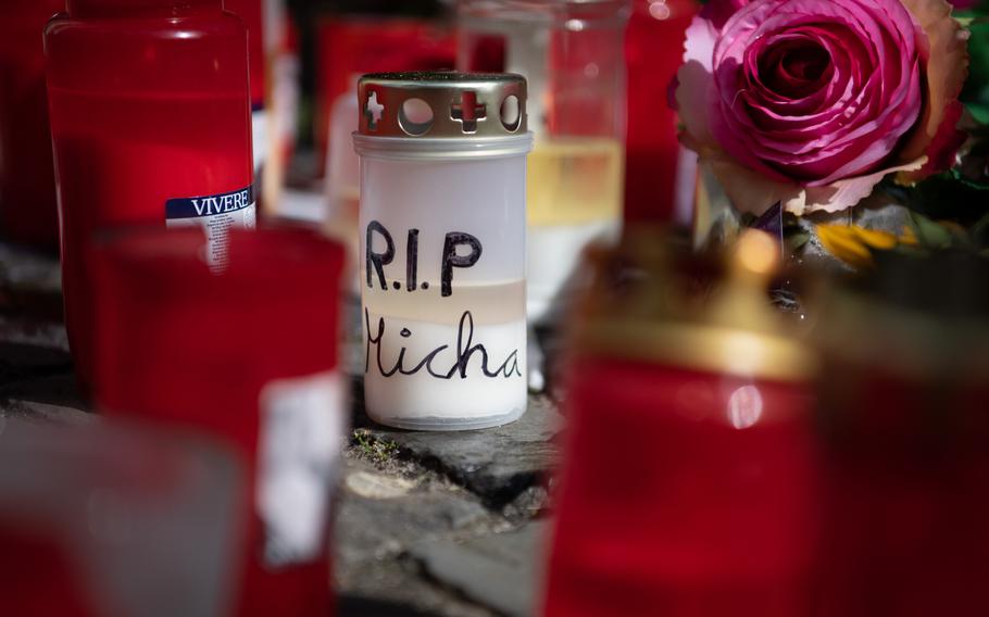 A candle with “RIP Micha” written on it is part of a memorial in Wittlich, Germany, for a 28-year-old man who was stabbed to death on Saturday.  Two American service members are being held on suspicion of the killing. 
