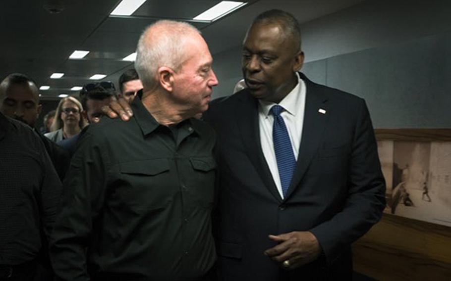 U.S. Defense Secretary Lloyd Austin talks with his Israeli counterpart Yoav Gallant in Tel Aviv, Oct. 13, 2023.