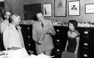 Hed: The Librarian and the General, 1955

Tokyo, Japan, Oct. 3, 1955: General Lyman Louis "L.L." Lemnitzer looks through some files in the Pacific Stars and Stripes library as librarian Toshi Tokunage looks on. Gen. Lemnitzer visited the paper's offices at Hardy Barracks on its 10th anniversary, Oct. 3, 1955. Accompanying him were Col. Karl W. Scherer, U.S. Army Forces Far East (AFFE)/Eighth Army chief of information; Lt. Col. Joe B. Goodrich, Troop Information and Education (TI&E) executive officer, and Maj. Jean W. Hollstein, one of the general’s aides.

Toshi Cooper (nee Tokunaga) was Stars and Stripes Pacific's librarian for decade, starting as the assistant librarian in 1948 but making herself quickly indispensable. 

Read an interview with Toshi on Stars and Stripes Pacific's 80 Anniversary page.
https://80.stripes.com/our-history/toshi-cooper-librarian

META TAGS: SSP 80 Anniversary; Pacific Stars and Stripes; Stars and Stripes History; Stars and Stripes personnel; newspaper history; organizational history; Toshi Cooper
