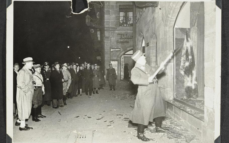 This photo released by Yad Vashem, World Holocaust Remembrance Center, shows German Nazis and civilians watch ransacking of Jewish property during Kristallnacht intake most likely in the town of Fuerth, Germany, on Nov. 10, 1938. The photos were taken by Nazi photographers during the pogrom in the city of Nuremberg and the nearby town of Fuerth. They wound up in the possession of a Jewish American serviceman who served in Germany during World War II. 