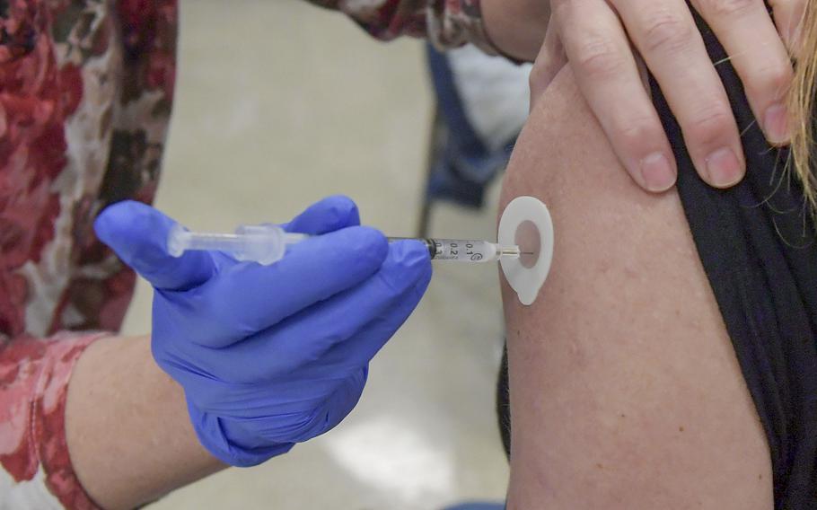 People get the COVID-19 vaccine shot on April 17, 2021, in Nevada, Iowa. According to reports on Nov. 23, 2021, an Iowa hospital administered the wrong dose of COVID-19 vaccines to more than 100 children.