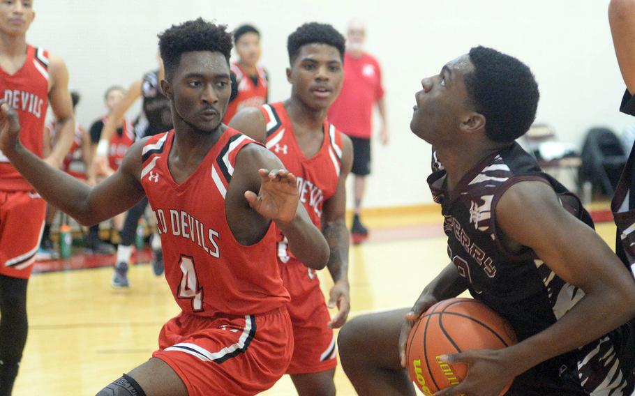 Matthew C. Perry's Tyzon Burnett tries to move to the basket against Nile C. Kinnick's Kennedy Hamilton during Saturday's Japan boys basketball game. The Samurai won 79-67.