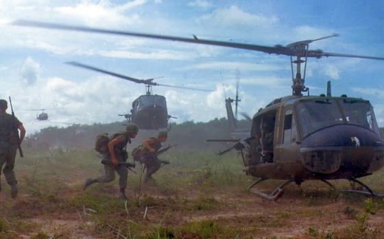 U.S. Army UH-1D Huey helicopters, similar to the one copiloted by Larry Zich when he crashed in 1972, airlift soldiers during a search-and-destroy mission in South Vietnam in 1966. 