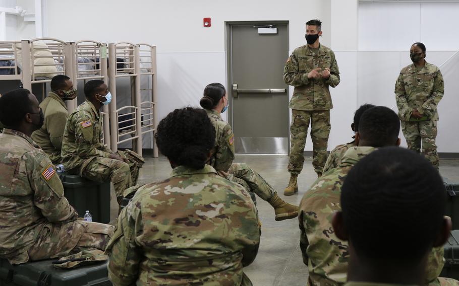 Army Col. Robert J. Coker, commander of the 642nd Regional Support Group, and brigade Command Sgt. Major Denise Demps discuss the dangers of extremist groups with troops during a combined training readiness exercise on April 24, 2021, at Fort McClellan, Ala. 