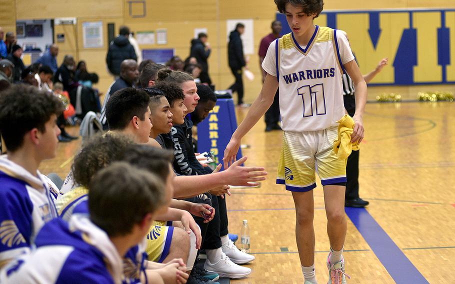 Wiesbaden's Gavin DeLuca is congratulated as he returns to the bench during the Warriors' 51-26 win over Baumholder on Friday at Wiesbaden High School in Wiesbaden, Germany.