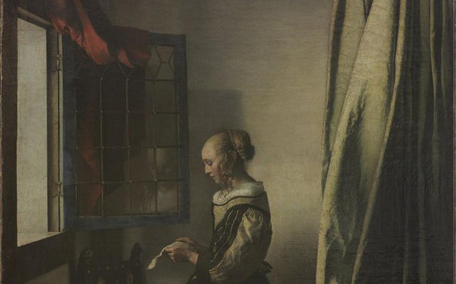 17th century painting by Dutch painter Johannes Vermeer, "Girl at an open window reading a letter," before its restoration in 2017.