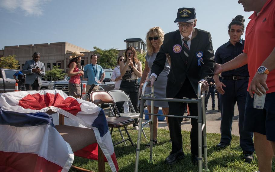 Norman Bramley celebrates his 100th birthday at the West Hartford town hall on Aug. 17, 2022. Bramley is a World War II veteran who served in the Air Force for five years in the Philippines. He is escorted by his son-in-law, Shawn Daigle and family friend, Patty Seaman. 