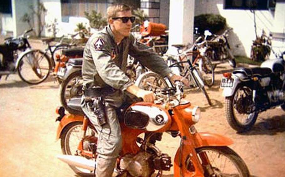 Air Force Col. Warren Anderson sits on a motorcycle in South Vietnam in this photo taken in 1965. He went missing about a year later when his RF-4C reconnaissance jet went off radar during a scouting mission over North Vietnam. 