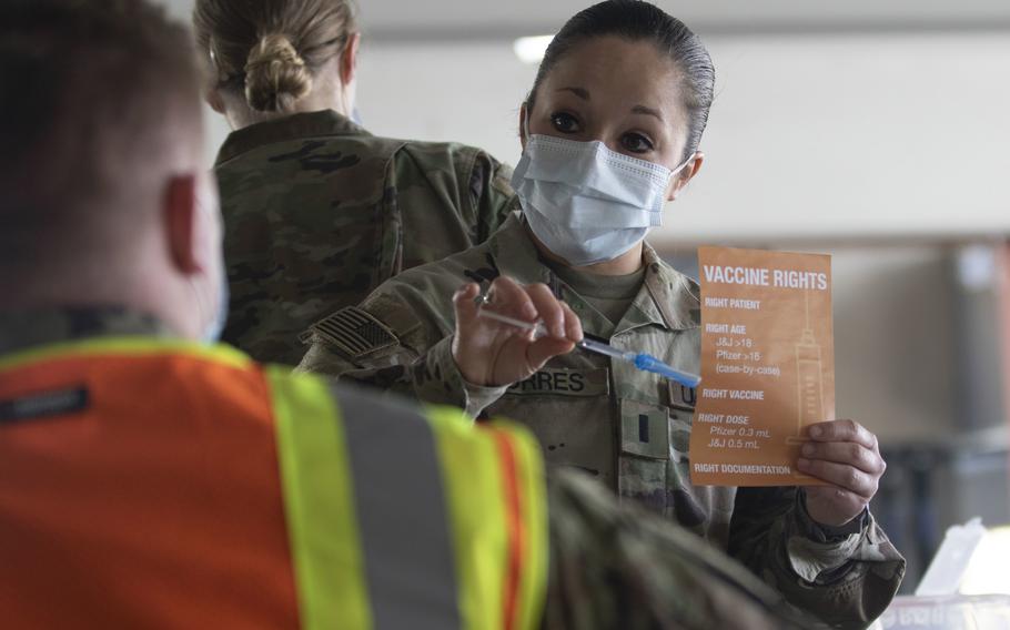 1st Lt. Michelle Torres teaches Army medics in Los Angeles about the variety of syringes used for a coronavirus vaccination. 