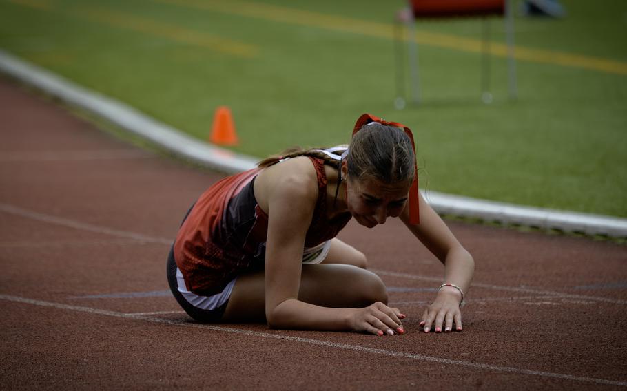 Kaiserslautern’s Alexandra Beck collapses after finishing 10th in the girls 3,200-meter run at the 2024 DODEA European Championships at Kaiserslautern High School in Kaiserslautern, Germany, on May 24, 2024.