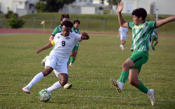 Kadena's Elijah Whipp looks to move around Kubasaki's Mateo Solano.