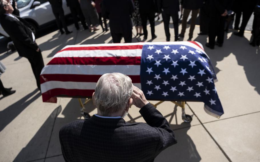 Robert Low salutes the casket of James Mulligan Jr. during his funeral Wednesday in Virginia Beach. Mulligan was one of the "Alcatraz 11," a group of American prisoners of war held captive during the Vietnam War. They returned to the U.S. in 1973.