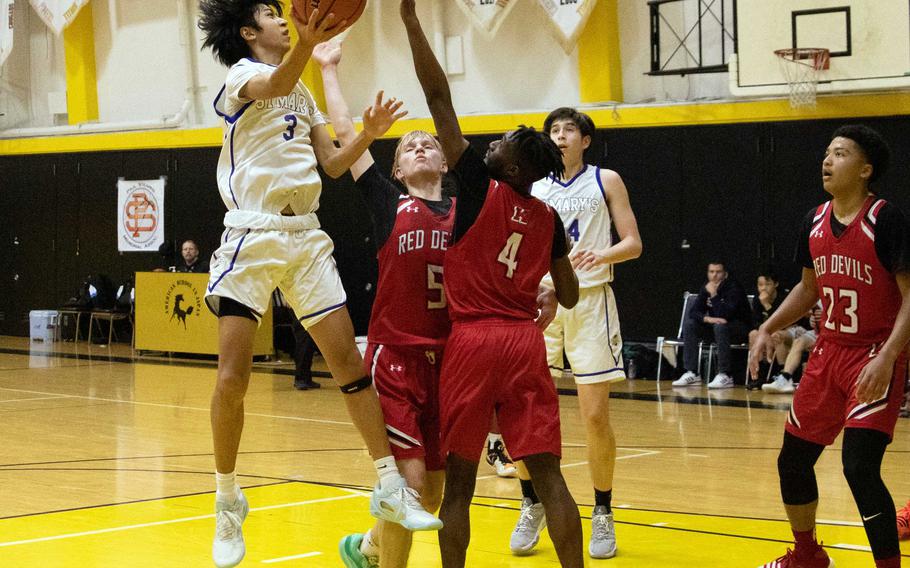 St. Mary's Towa Miyoshi tries to shoot over Nile C. Kinnick's Kennedy Hamilton. Miyoshi hit the game-winning basket as the Titans won the ASIJ Kanto Classic boys final 40-38. Miyoshi was named the tournament's MVP.