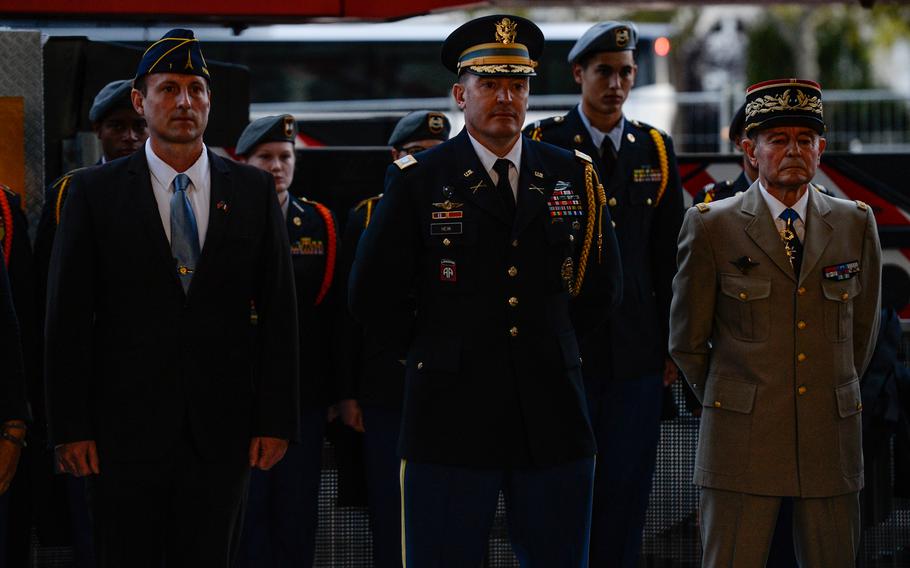 Representatives of the American Legion, U.S. and French armies stand for the beginning of a wreath-laying ceremony at the Arc de Triomphe in Paris, Oct. 26, 2021. The ceremony honored the Tomb of Unknown Soldier of France, which inspired its counterpart at Arlington National Cemetery 100 years ago.