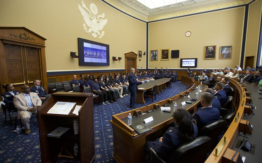 Someone in uniform speaking in front of an audience and future airmen.