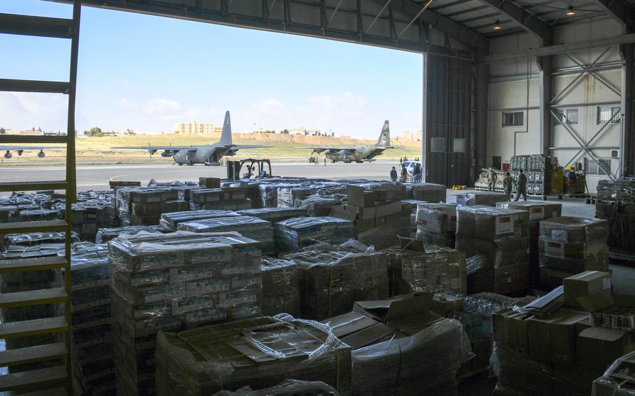 Pallets of food and other forms of humanitarian aid, emblazoned with the flags of the nations that donated them, wait in a warehouse in Jordan on Wednesday, March 20, 2024, to be airdropped into Gaza. 
