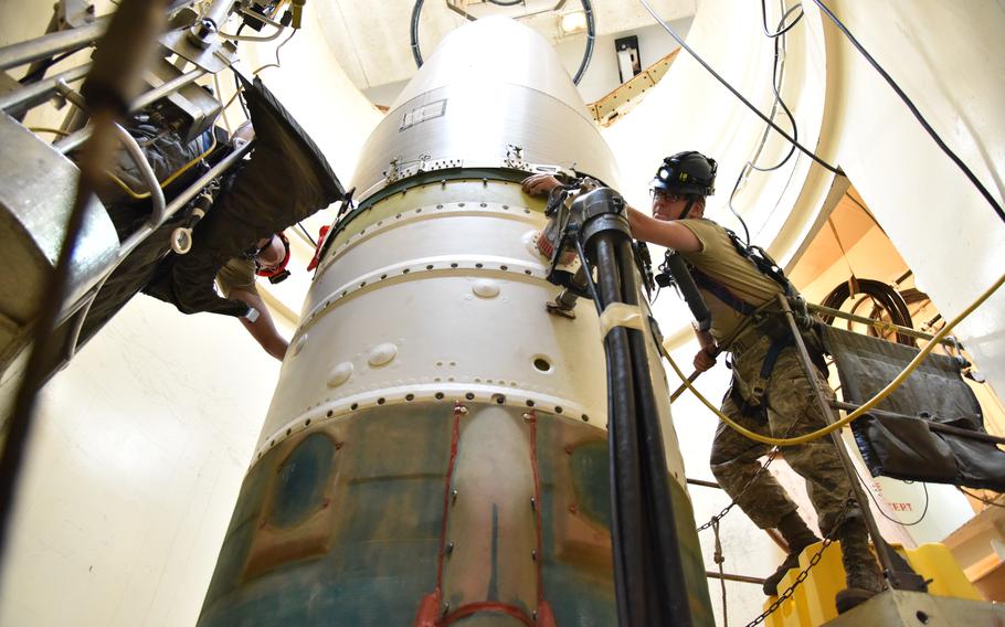 Airman 1st Class Jackson Ligon, left, and Senior Airman Jonathan Marinaccio, 341st Missile Maintenance Squadron technicians, connect a reentry system on an intercontinental ballistic missile during a Simulated Electronic Launch-Minuteman test Sept. 22, 2020, at a launch facility near Great Falls, Mont. 