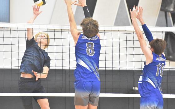 Black Forest Academy's Timothy Sivonen gets set to tip the ball past the Rota block of Tyler DeMeritt, left, and Jackson Warkentien in the Falcons' straight-set victory over the Admirals in the DODEA-Europe boys volleyball championships Saturday, Oct. 28, 2023, in Vicenza, Italy.

Kent Harris/Stars and Stripes