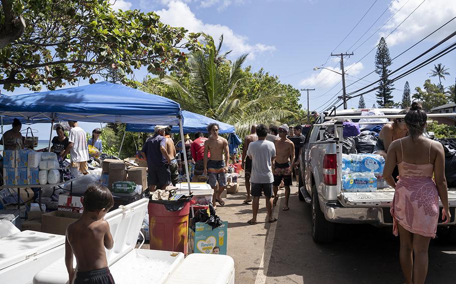 Local residents gather to distribute supplies to those in need after the Maui fire in the Kahana community of Hawaii on Friday, Aug. 11, 2023.
