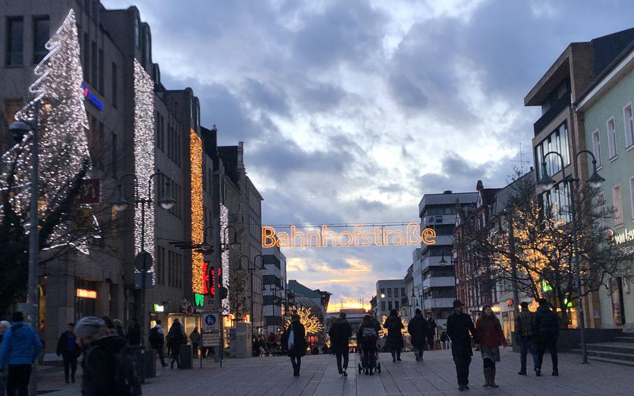People walk along the pedestrian zone in Fulda, Germany, on Thursday, Dec. 29, 2022, on an unseasonably warm evening.