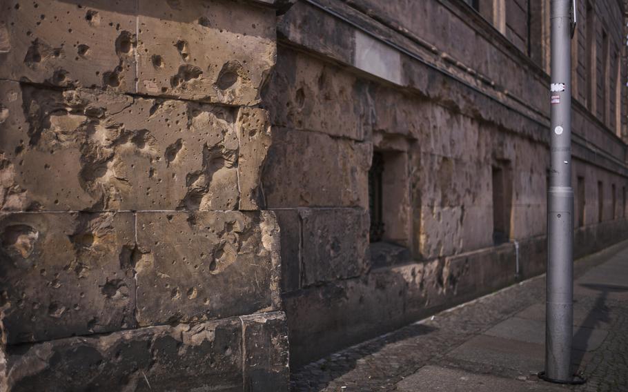 Holes from artillery fire are visible on the facade of a house in Berlin.