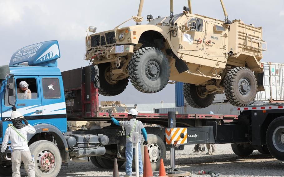 A Mine Resistant Ambush Protected vehicle is loaded on a flatbed trailer as part of the Army Field Support Battalion - Afghanistan, 10th Mountain Division cargo drawdown operation on Bagram Airfield, Afghanistan, July 12, 2020. 