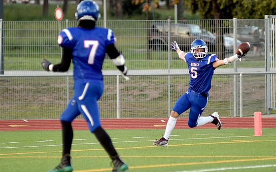 Ramstein receiver Caden Nims celebrates after catching a 39-yard touchdown pass during the Royals' 14-9 win over Stuttgart on Sept. 8, 2023, at Ramstein High School on Ramstein Air Base, Germany. In the foreground is teammate J.Q. Estell.