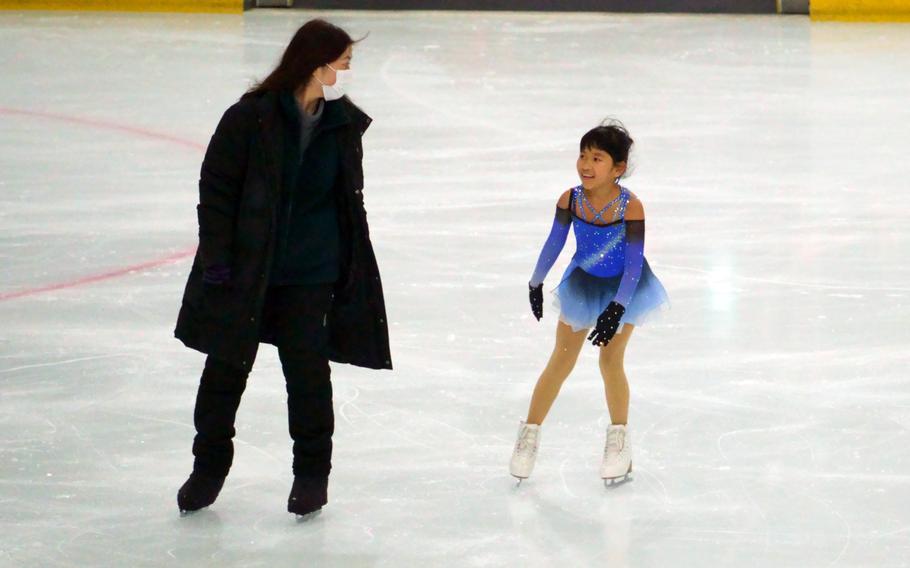 Ava Jade Gurski, 9, skates during alongside her coach, Nozomi Watanabe, at Kose Shin Yokohama Skate Center, Oct. 20, 2022.
