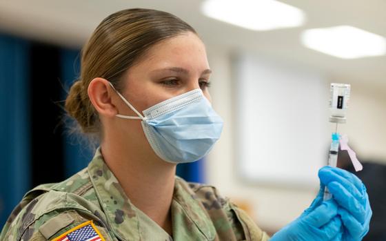 A member of the Oklahoma National Guard prepares to administer a COVID-19 vaccine on  Feb. 23, 2021.  