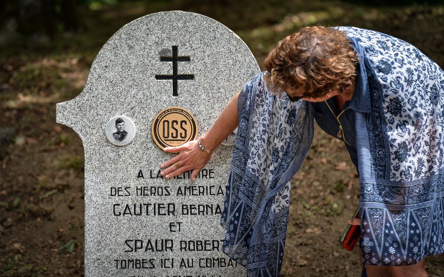 Jamie Jamison gently touches a commemorative stele that marks the area where her great uncle died in 1944 during a visit to the site near Le Rialet, France, May 28, 2022. Jamison is the great niece of Bernard Gautier, one of the two Office of Strategic Services men killed during a firefight with German troops.
