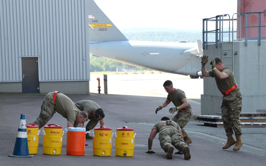 The Raven's Fury team out of Spangdahlem Air Base does 75 burpees at the start of the endurance event of the 721st Aerial Port Squadron's Multi-Capable Airmen Rodeo at Ramstein Air Base, July 23, 2021.