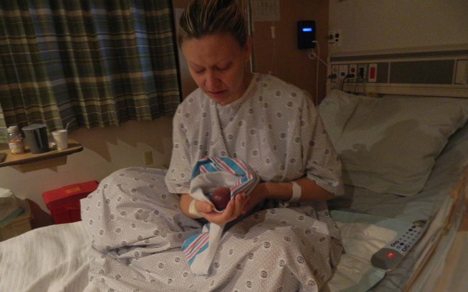 Bari Wald, an Air Force Reserve officer and Marine’s wife, held her deceased fetus after delivering him in 2015. The baby had been diagnosed with catastrophic birth defects at 19 weeks’ gestation. The military does not provide access or funds for therapeutic abortions for fetal abnormalities but Wald ended up at Naval Hospital Okinawa because of a botched procedure in a Japanese hospital that she says left her near death. 