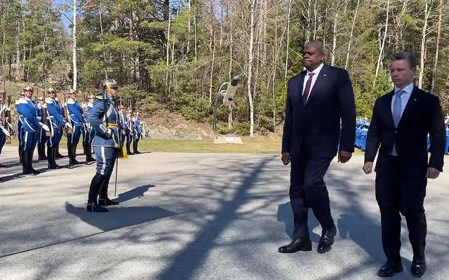Defense Secretary Lloyd Austin and Swedish Defense Minister Pal Jonson attend a Swedish military demonstration in Stockholm, April 19, 2023, during their bilateral meeting.