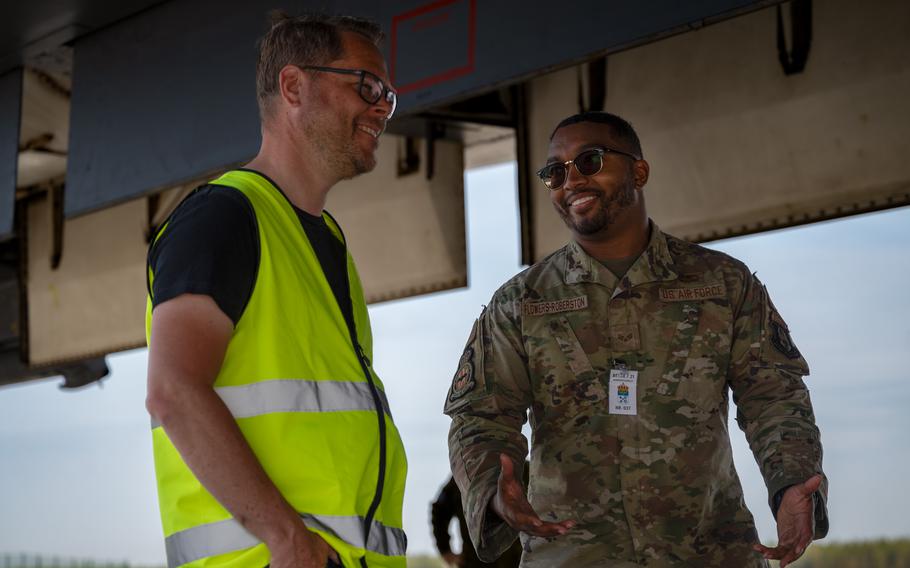 Senior Airman Marquis Flowers-Robertston, a B-1B Lancer crew chief, talks to a reporter about the aircraft at Lulea Kallax Air Base, Sweden, June 20, 2023. Two Lancers landed in Sweden for the first time.