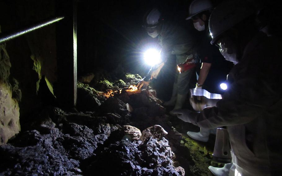 Okinawa government officials inspect the underground headquarters of Imperial Japan's 32nd Army in Naha, Okinawa, Jan. 22, 2021.
