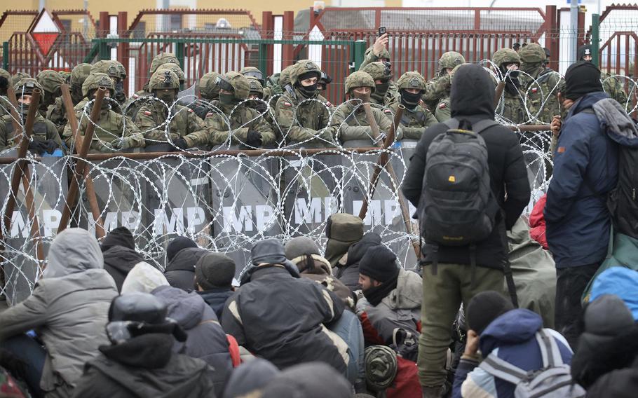 Migrants from the Middle East and elsewhere gather at the checkpoint "Kuznitsa" at the Belarus-Poland border near Grodno, Belarus, on Monday, Nov. 15, 2021. 