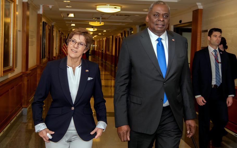 Defense Secretary Lloyd Austin and his German counterpart Annegret Kramp-Karrenbauer walk through the Pentagon,  June 30, 2021. Among other matters, they discussed  income tax penalties imposed on hundreds of Defense Department personnel, which the U.S. says violates a treaty.