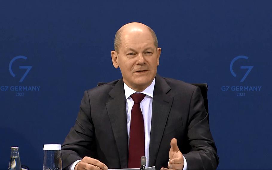 German Chancellor Olaf Scholz talks with reporters Feb. 16, 2022, in Berlin following a conference with state governors to discuss loosening coronavirus restrictions.