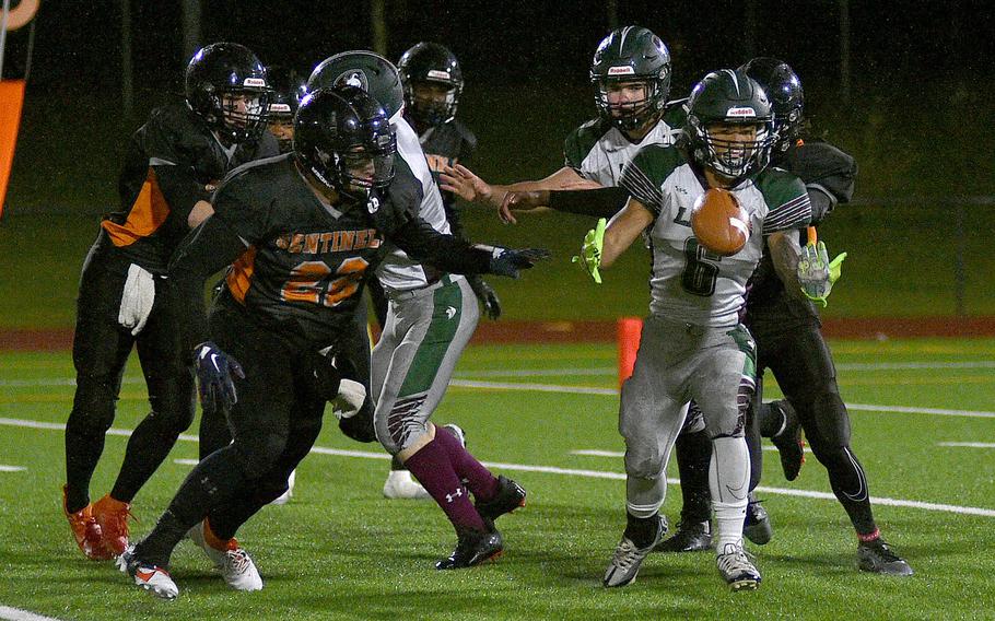 AFNORTH running back Connor Luminarias struggles to handle the football while Spangdahlem's Casey Supinger goes toward him during the DODEA-Europe Division III championship game on Oct. 29, 2023, at Spangdahlem High School in Spangdahlem, Germany.