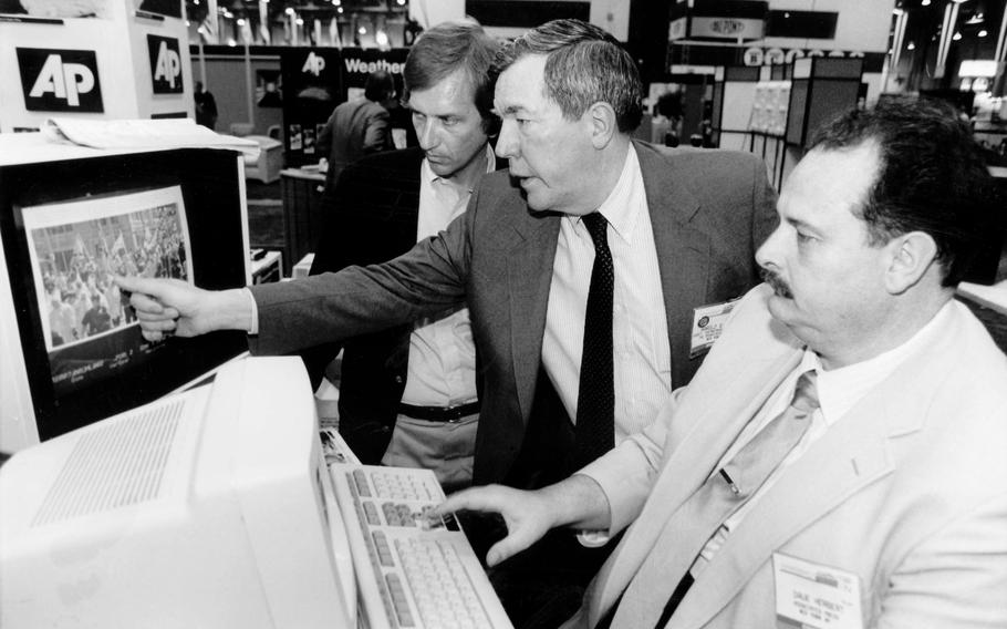 The Associated Press’ assistant general manager for news photos Hal Buell, center, and Dave Herbert, right, the consultant who wrote the electronic darkroom software, explain PhotoStream at the American Newspaper Publishers Association technical convention in Las Vegas in June 1987. Buell, who led The Associated Press’ photo operations from the darkroom era into the age of digital photography over a four-decade career with the news organization that included 12 Pulitzer Prizes and running some of the defining images of the Vietnam War, has died. Buell died Monday, Jan. 29, 2024, in Sunnyvale, Calif., where his daughter lived, after battling pneumonia. He was 92.