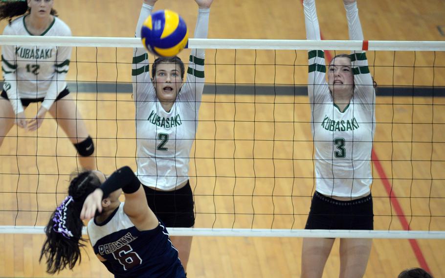 Seisen's Ann Katashiba readies a spike against Kubasaki's Grace Berrens and Adria Lockhart.