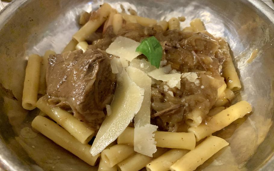 Pasta with Genovese is a traditional Neapolitan favorite featuring slow-cooked onions over pasta that is topped with chunks of tender beef and parmesan cheese. It's a first course pasta at Tufo in Naples' Posillipo neighborhood.